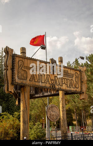 Wooden carved entrance sign to Ala Archa National Park, Kyrgyzstan. Stock Photo