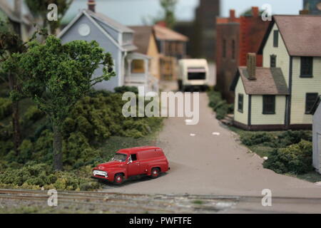 Really fantastic model railroading design of a residential neighborhood with homes and a red station wagon in the Clarendon Garfield field house in Chicago, Illinois. Stock Photo