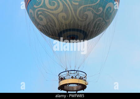 Orlando, Florida. September 27, 2018. People flying on air balloon at Disney Springs on light blue sky background. Stock Photo