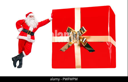 Cheerful Santa Claus stands by the large Christmas gift box isolated on a white background. Funny jovial Santa offer the big Xmas present Stock Photo Alamy