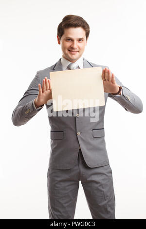 Businessman showing signboard. In studio on a white background. Stock Photo