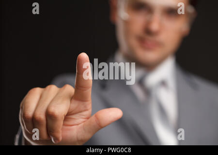 business, technology, internet and networking concept - businessman pressing button with contact on virtual screens. Stock Photo