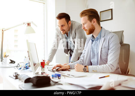 Coworkers working on project together Stock Photo