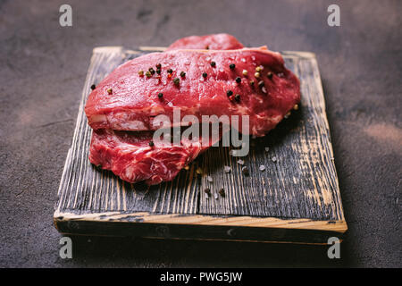 Close up of two peaces of beaf steak on wooden board. Copa space Stock Photo