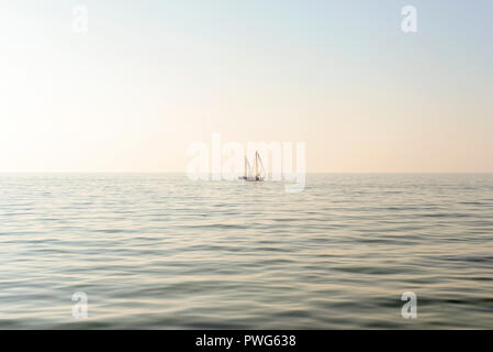 Two sailboats with white sails in the sea Stock Photo