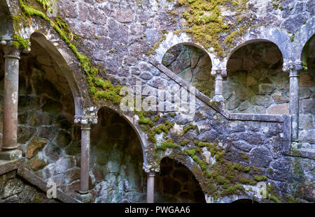 A staircase descending in a spiral along the walls of Initiation Well (Inverted tower) in Quinta da Regaleira estate. Sintra. Portugal Stock Photo