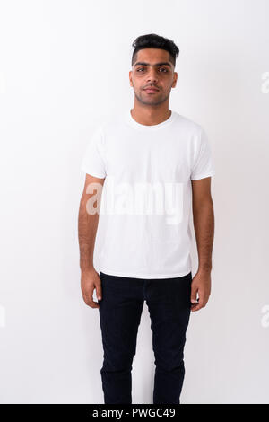 Young Indian man wearing white shirt against white background  Stock Photo
