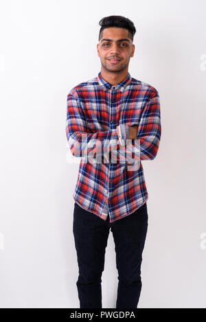 Young Indian man wearing checkered shirt against white backgroun Stock Photo