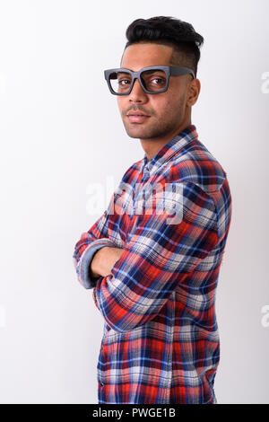 Young Indian man wearing checkered shirt against white backgroun Stock Photo