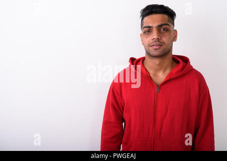 Young Indian man wearing hoodie against white background Stock Photo