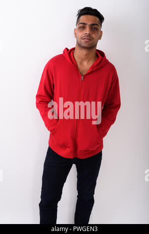 Young Indian man wearing hoodie against white background Stock Photo