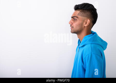 Young Indian man wearing hoodie against white background Stock Photo