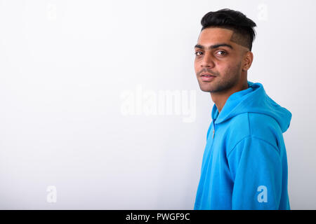 Young Indian man wearing hoodie against white background Stock Photo