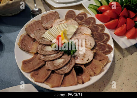 Slices of Shuzhuk horse meat sausage served with goat cheese in a restaurant in Samarkand Uzbekistan Stock Photo