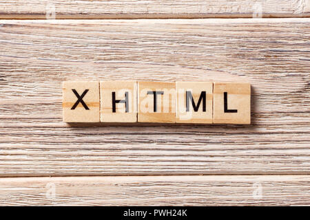 XHTML word written on wood block. XHTML text on table, concept. Stock Photo