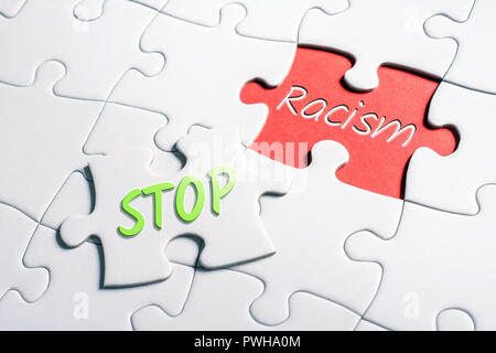 The Words Stop And Racism In Missing Piece Jigsaw Puzzle Stock Photo