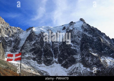 Aiguille du Midi (3,842 m / 12,605 ft) and the flag of Haute-Savoie, Mont Blanc massif, Chamonix-Mont-Blanc, French Alps, France. Stock Photo