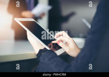 businessmen and group using notebook and tablet for business partners discussing documents and ideas at meeting Stock Photo