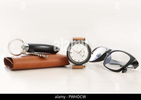 Picture of watch, car key, glasses and wallet. Isolated on white background. Stock Photo