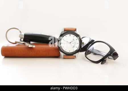 Picture of watch, car key, glasses and wallet. Isolated on white background. Stock Photo