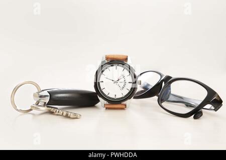 Picture of watch, car key and glasses. Isolated on white background. Stock Photo