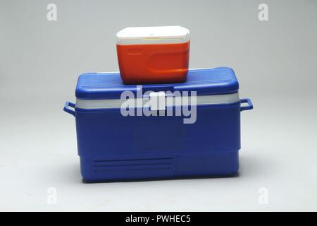 Red and Blue Handheld  refrigerator, ice box over white background. Stock Photo