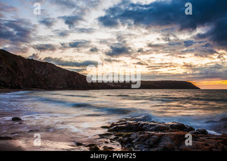 Sunset over the beach at Tresaith in Ceredigion, Wales, looking towards Aberporth. Stock Photo