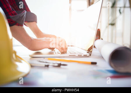 Architect man working on laptop with project control and construction project management at construction site Stock Photo