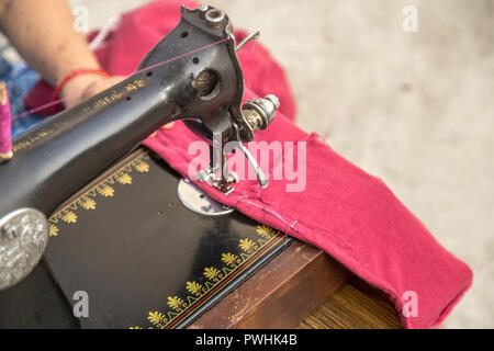 Cropped close up of a woman using sewing machine Stock Photo
