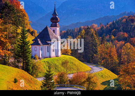 Autumn in Alps. Image of the Bavarian Alps with Maria Gern Church and Watzmann mountain during beautiful autumn day. Stock Photo