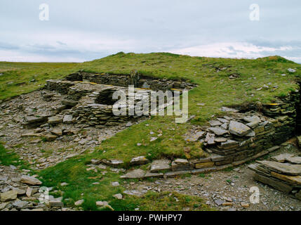 View SW of Isbister Neolithic chambered cairn, Orkney, Scotland, UK, showing the oval cairn with its entrance passage facing E out to sea on the L. Stock Photo