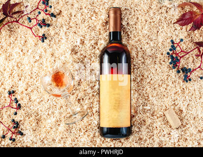 Bottle of wine presentation on sawdust background Stock Photo