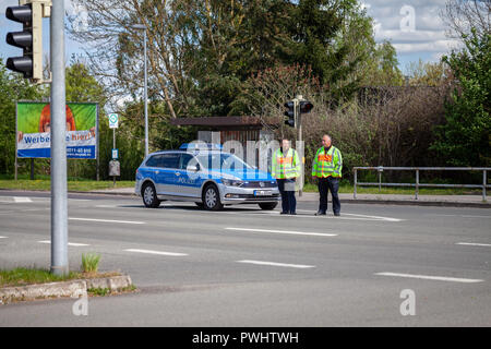 ALTENTREPTOW / GERMANY - MAY 1, 2018: German police car with two policeman stands on a street Stock Photo