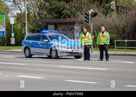 ALTENTREPTOW / GERMANY - MAY 1, 2018: German police car with two policeman stands on a street Stock Photo