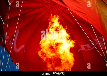 Flames inflating a Virgin hot air balloon on York Racecourse, North Yorkshire Stock Photo