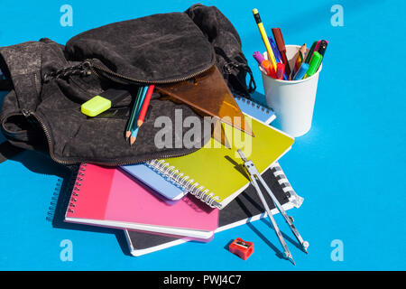 Backpack with school supplies - notebooks, penciles, divider, pencil sharpener and ruler Stock Photo