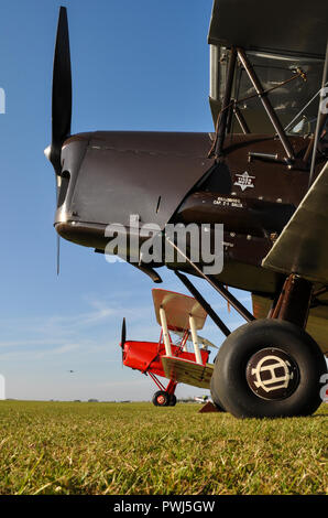 Tiger Moth biplanes sitting on the grass at Duxford airfield. de Havilland DH82 Tiger Moth plane. Vintage aircraft. Planes. Airplanes. Aviation Stock Photo