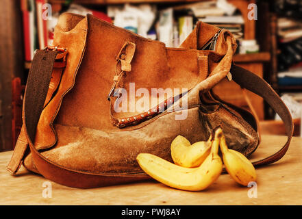 Light orange old suede bag and three ripe bananas Stock Photo