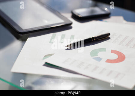 Financial paper charts and graphs on the table Stock Photo