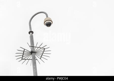 CCTV surveillance camera & bleak grey sky. Surveillance State & crime prevention metaphor, security system, privacy campaigners, face recognition. Stock Photo
