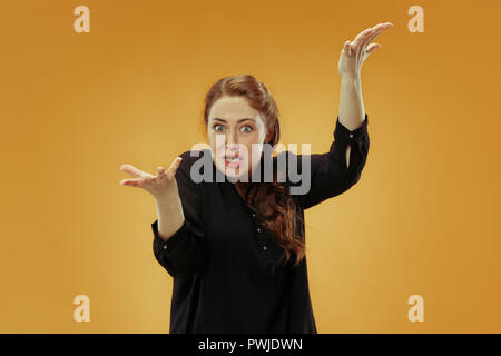 Argue, arguing concept. Beautiful female half-length portrait isolated on studio backgroud. Young emotional surprised woman looking at camera.Human emotions, facial expression concept. Stock Photo