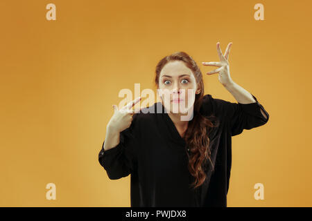 Argue, arguing concept. Beautiful female half-length portrait isolated on studio backgroud. Young emotional surprised woman looking at camera.Human emotions, facial expression concept. Stock Photo
