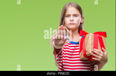 Young beautiful girl giving christmas or valentine gift over isolated background with open hand doing stop sign with serious and confident expression, Stock Photo