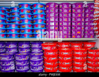 Christmas boxes of candy or chocolates or sweets stacked on a shop shelf. Stock Photo