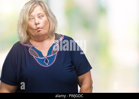 Senior plus size caucasian woman over isolated background making fish face with lips, crazy and comical gesture. Funny expression. Stock Photo