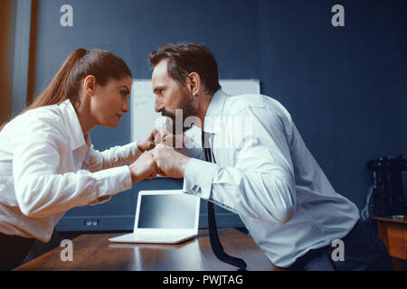 Young businessman and businesswoman compete Stock Photo