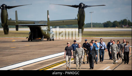 Brig. Gen. Anthony Genatempo, Air Force Life Cycle Management Center commander and Congressman Matt Gaetz, 1st District of Florida, walk out to welcome President Donald J. Trump on the flightline Oct. 15 at Eglin Air Force Base, Fla. Trump stopped at Eglin on his way to Panama City to see the devastation from Hurricane Michael.  The President exited Air Force One, met with Florida and base leadership, as well as the media before departing to the east on his helicopter. (U.S. Air Force photo/Ilka Cole) Stock Photo