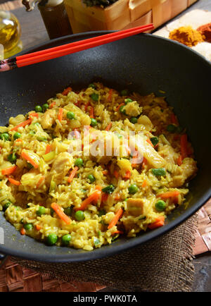 Traditional indonesian meal nasi goreng with rice, vegetables and chicken Stock Photo