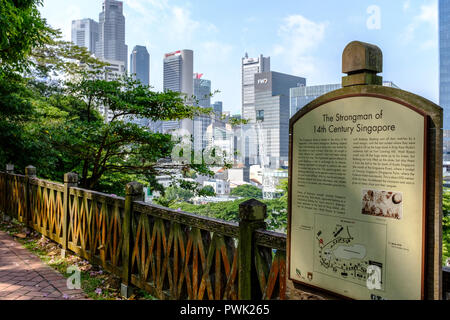 View of Singapore central business district through lush tropical vegetation of historic colonial Fort Canning Park Stock Photo