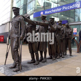 Manchester, UK. 16th October, 2018. Marking the centenary of the end of the First World War, a statue of seven blinded soldiers has been unveiled outside the main entrance of Manchester Piccadilly Railway Station. Entitled, 'Victory Over Blindness' it was commissioned by the military charity Blind Veterans UK. The original sculpture was conceived and designed by artist and sculptor Johanna Domke-Guyot. Credit: Terry Waller Alamy Live News Stock Photo